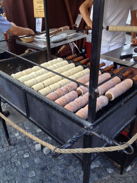 Traditional trdelnik being cooked on an open flame